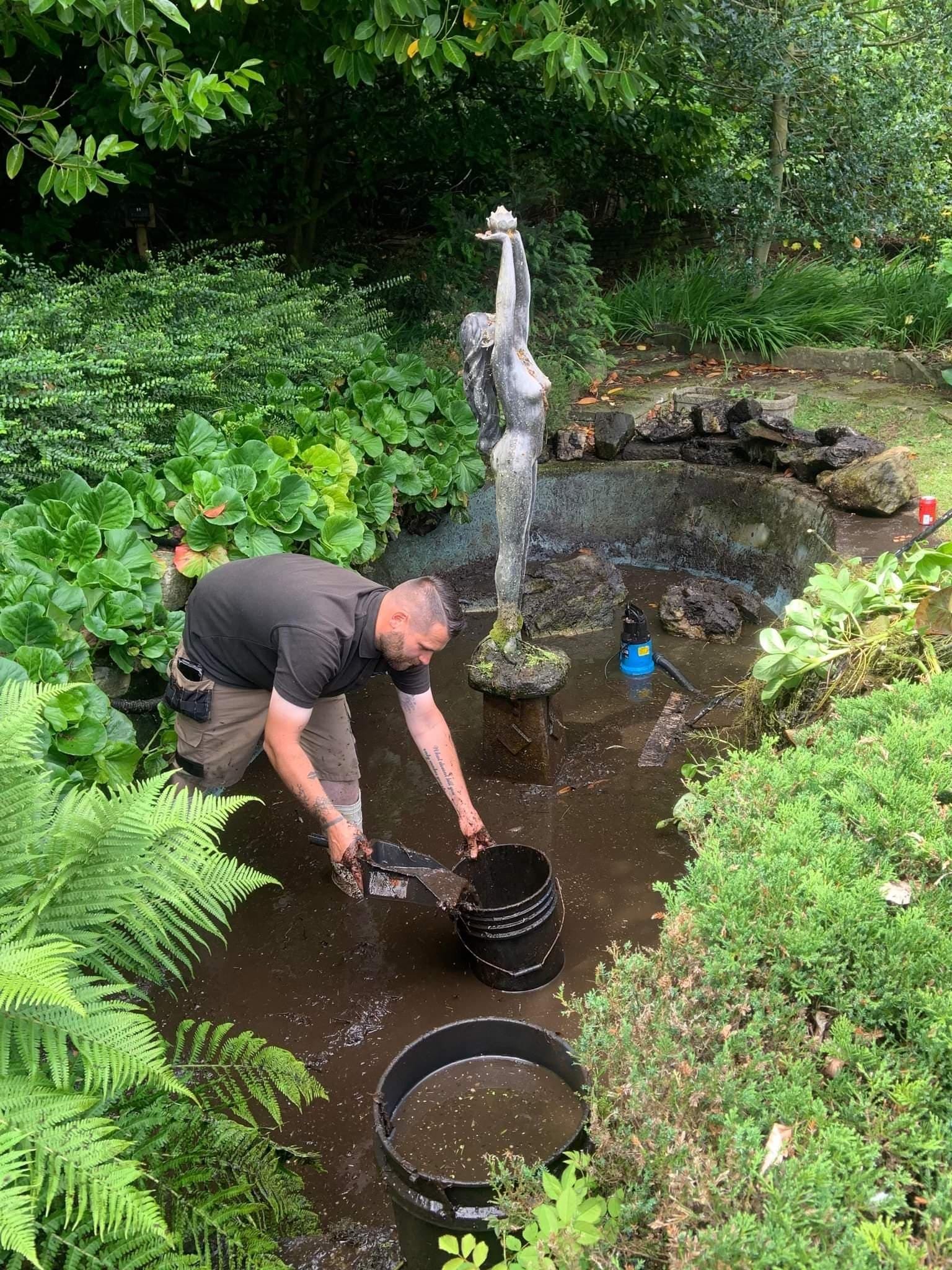 Jamie cleaning a koi pond